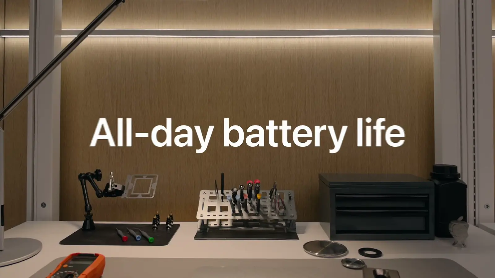 Keynote slide over an engineering bench: All-day battery life