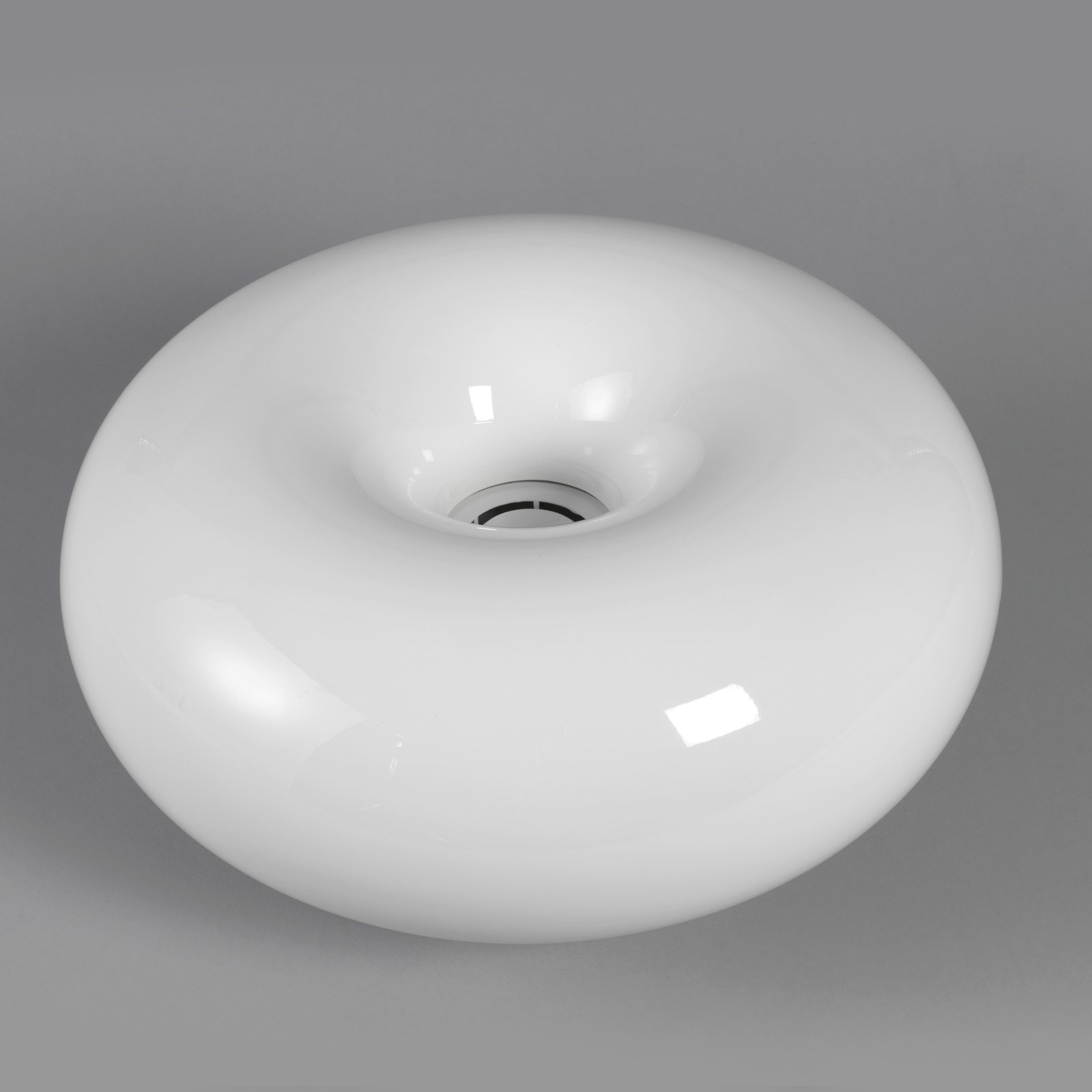 The doughnut-shaped ±0 humidifier by Naoto Fukasawa, 2003, in Cooper Hewitt's collection photograph: a glossy white rounded toroid on a plain gray background, the mist nozzle recessed at its center