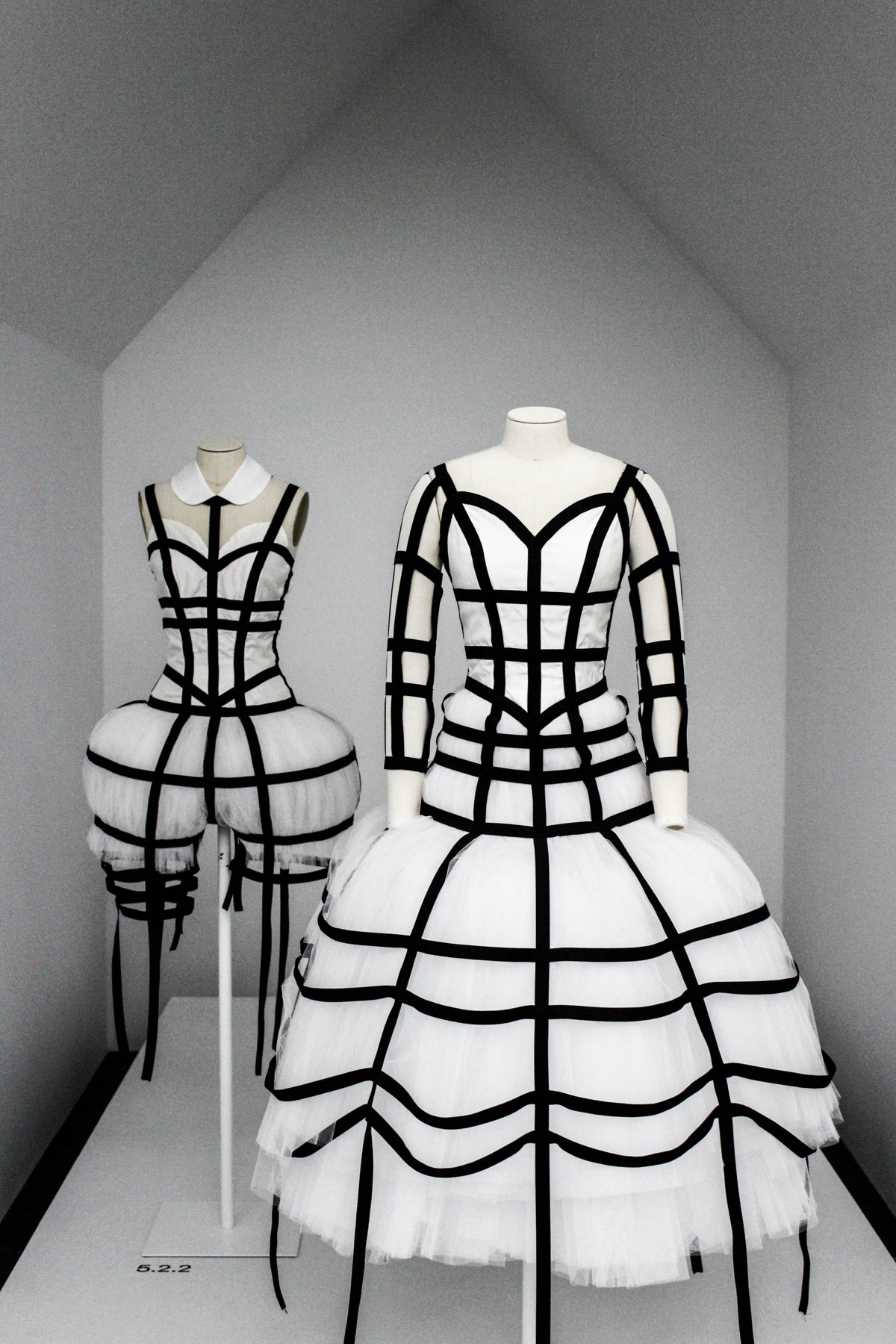 Comme des Garcons cage dresses over white tulle, installed at the Met's Art of the In-Between, 2017