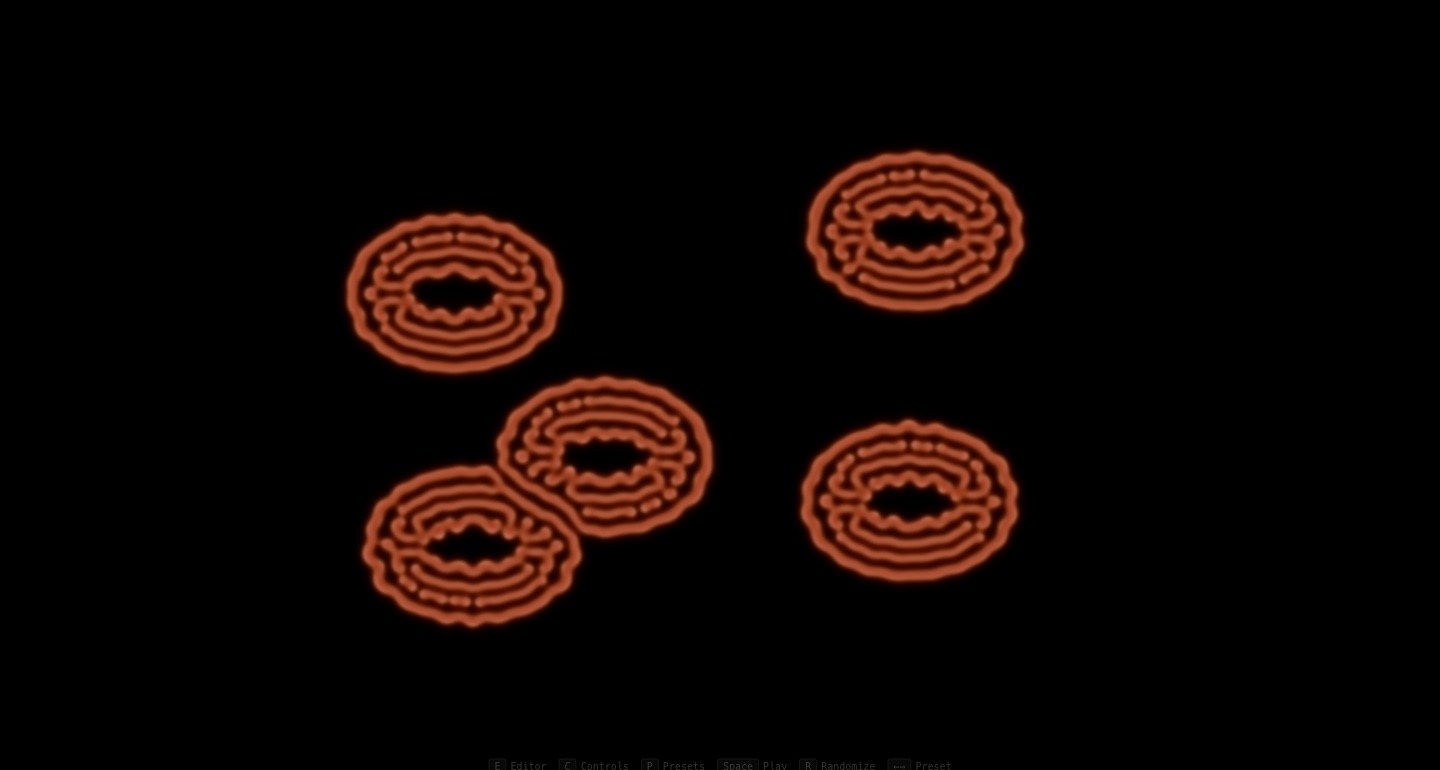 Gray-Scott reaction-diffusion rings growing on the repaired playground, orange ringed cells with fringing instabilities on black